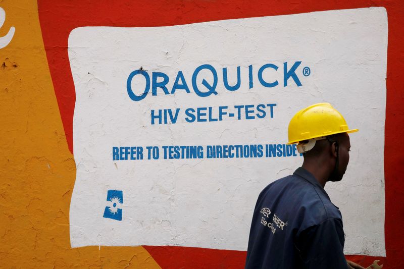 FILE PHOTO: A man walks past an advertisement for the OraQuick HIV self-testing kit, manufactured by OraSure Technologies, in the Mathare slum, in Nairobi, Kenya, October 30, 2020. REUTERS/Baz Ratner/File Photo