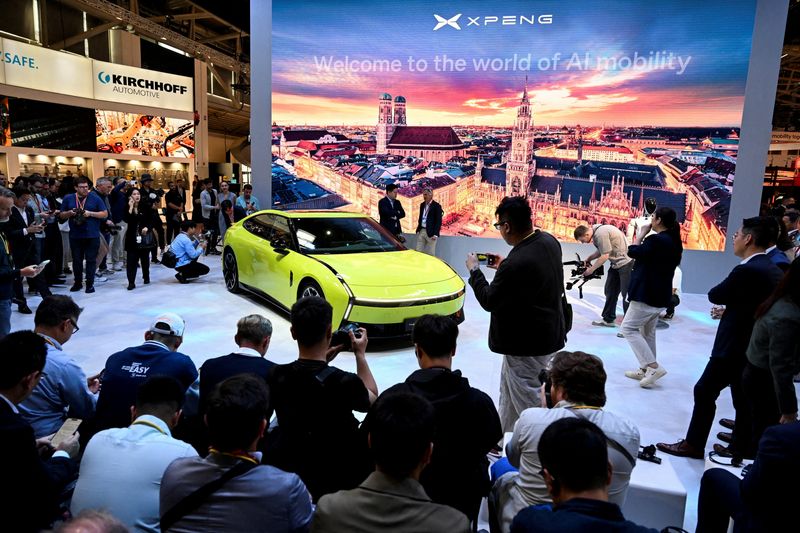 FILE PHOTO: People look at the Xpeng P7 on the press and media day of the IAA auto show in Munich, Germany, September 8, 2025. REUTERS/Angelika Warmuth/File Photo