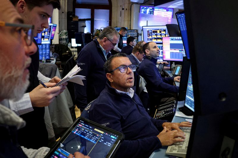 FILE PHOTO: Traders work on the floor at the New York Stock Exchange (NYSE) in New York City, U.S., March 2, 2026.  REUTERS/Brendan McDermid/File Photo