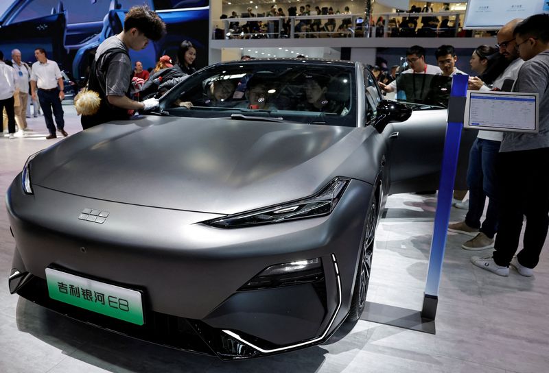 FILE PHOTO: A staff member cleans the Geely Galaxy E8 electric vehicle at the Beijing International Automotive Exhibition, or Auto China 2024, in Beijing, China, April 25, 2024. REUTERS/Tingshu Wang/File Photo