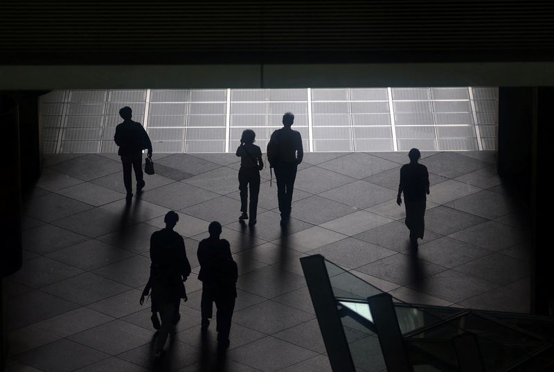 People walk through a convention hall in Tokyo, Japan, May 15, 2025.  REUTERS/Issei Kato