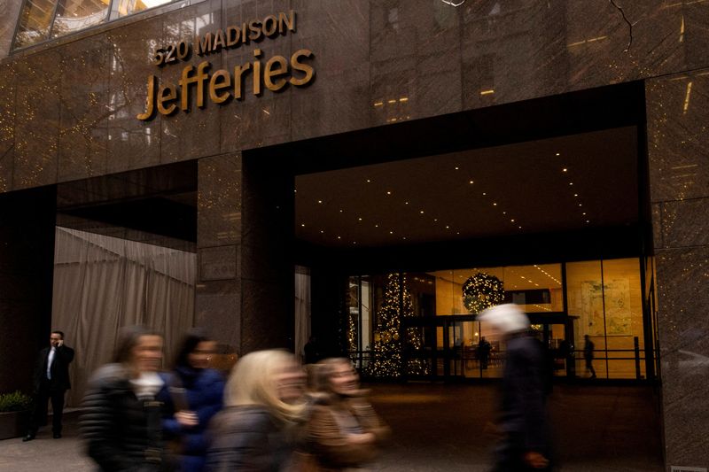 FILE PHOTO: People walk outside of Jefferies Financial Group offices in Manhattan, New York, U.S., December 8, 2021. REUTERS/Eduardo Munoz/File Photo