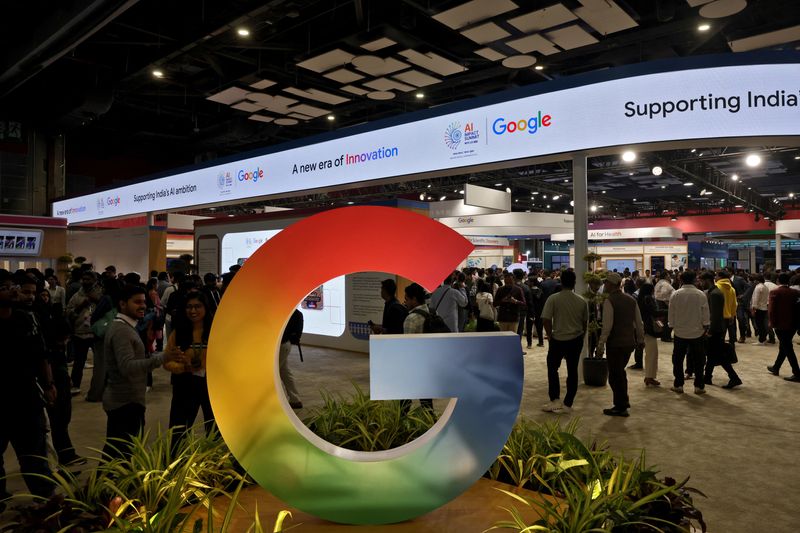 Visitors walk near a logo of Google at Bharat Mandapam, one of the venues for AI Impact Summit, in New Delhi, India, February 17, 2026. REUTERS/Bhawika Chhabra
