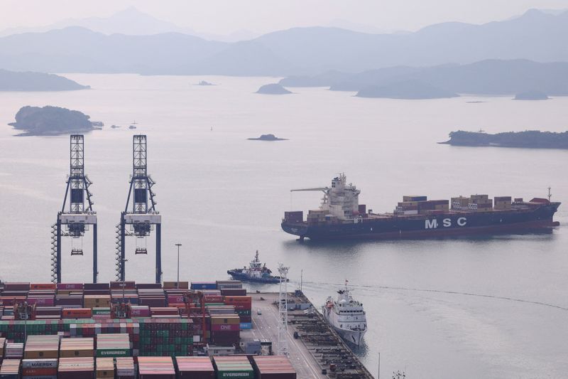 FILE PHOTO: A cargo ship carrying containers approaches a terminal of the Yantian port in Shenzhen, Guangdong province, China October 30, 2025. REUTERS/Tingshu Wang/File Photo