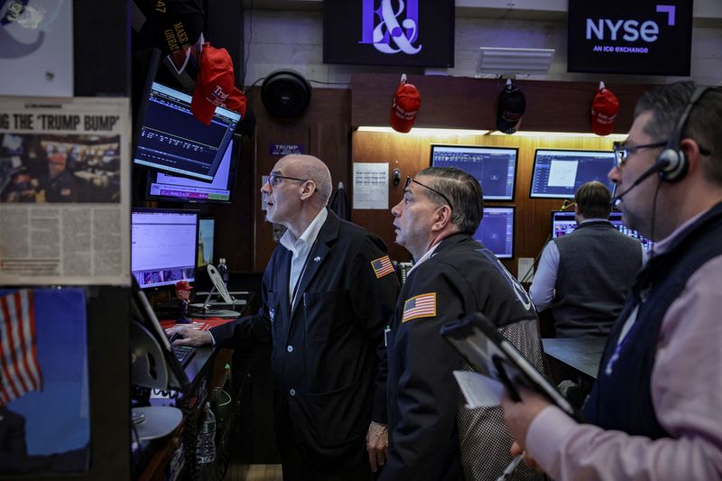 Traders work on the floor at the New York Stock Exchange (NYSE) in New York City, U.S., March 24, 2026. REUTERS/Jeenah Moon