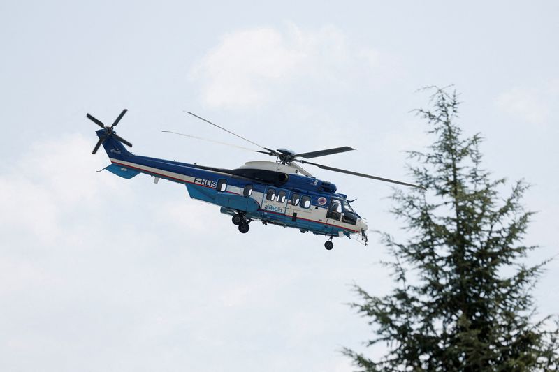 FILE PHOTO: An Airbus H225 helicopter flies over an area in Landiras, in the Gironde region, France, July 22, 2022. REUTERS/Benoit Tessier/File Photo
