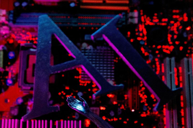 FILE PHOTO: AI (Artificial Intelligence) letters and robot hand are placed on computer motherboard in this illustration created on June 23, 2023. REUTERS/Dado Ruvic/Illustration/File Photo