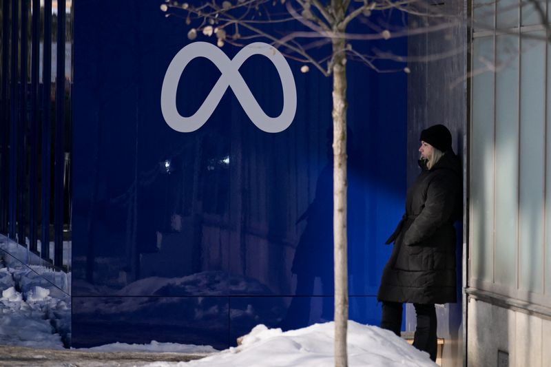 A woman stands near a Meta logo during the 56th annual World Economic Forum (WEF) meeting, in Davos, Switzerland, January 20, 2026. REUTERS/Romina Amato