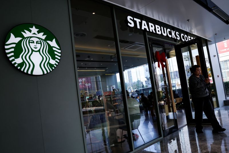 A customer walks out of a Starbucks coffee shop in Beijing, China, November 4, 2025. REUTERS/Tingshu Wang