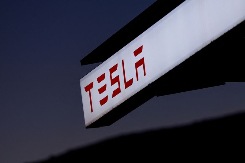 A view of Tesla logo at an electric vehicle charging station between Los Angeles and Las Vegas in Baker, California, U.S., November 19, 2024.  REUTERS/Mike Blake/File Photo