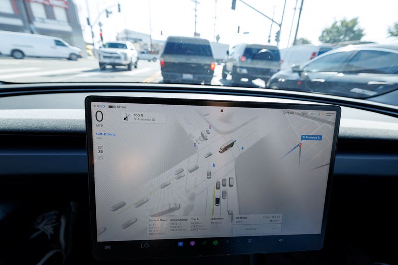 A 2025 Tesla Model 3 self-drives on the streets of Los Angeles, California, U.S., November 6, 2025. REUTERS/Mike Blake