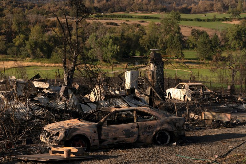 The remnants of burned homes and cars are seen along a rural highway after a wildfire came through the area near Eagle Point, Oregon, U.S. September 19, 2020.  REUTERS/David Ryder