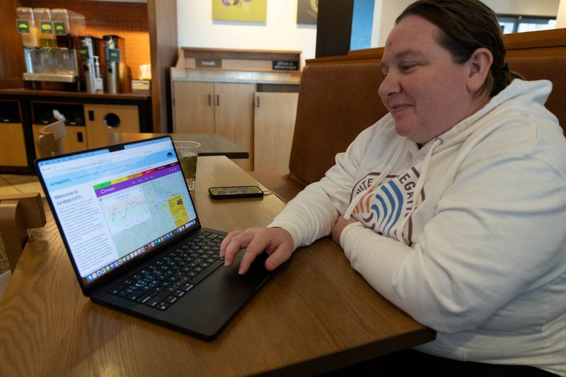 Beth Gutzler views air quality data on the AirWatchSTL website on a laptop in Florissant, Missouri, U.S., February 18, 2026. REUTERS/Lawrence Bryant