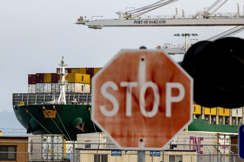 FILE PHOTO: A view of cargo ship with shipping containers at the port of Oakland following the Supreme Court's ruling that Trump had exceeded his authority when he imposed tariffs, in Oakland, California, U.S., February 23, 2026. REUTERS/Carlos Barria/File Photo