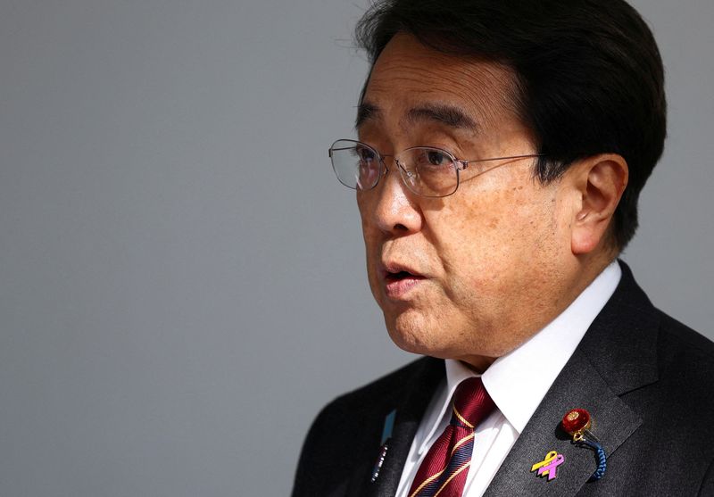 FILE PHOTO: Japan's Economic Revitalization Minister Ryosei Akazawa speaks to the press upon his arrival at Haneda Airport, a day after ministerial talks on tariffs, with U.S. President Donald Trump joining the negotiators, in Tokyo, Japan, April 18, 2025. REUTERS/Issei Kato/File Photo