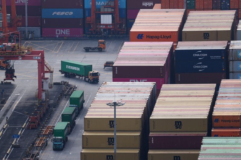 Trucks carrying containers move at a terminal of the Yantian port in Shenzhen, Guangdong province, China October 30, 2025. REUTERS/Tingshu Wang