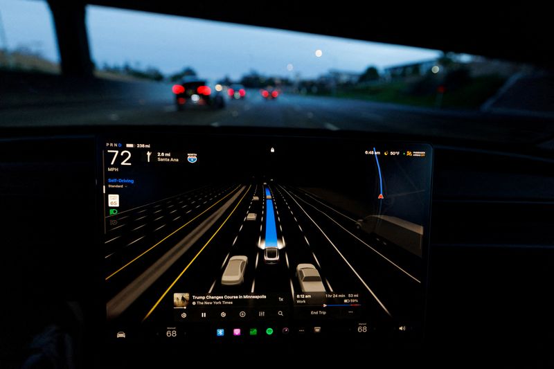 FILE PHOTO: A Tesla Model 3 is shown driving on the highway with FSD 14.2.2.3 self-driving supervised software in Irvine, California, U.S., January 28, 2026. REUTERS/Mike Blake/File Photo