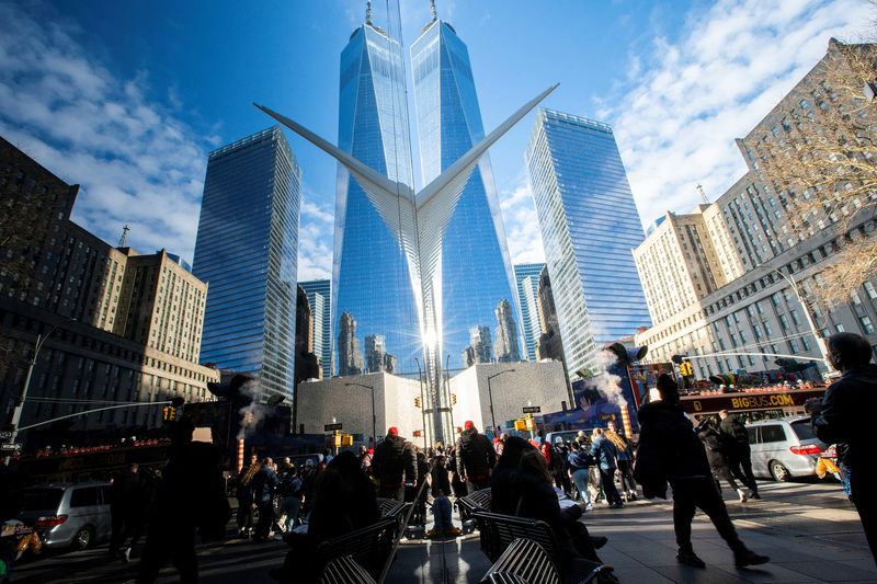 FILE PHOTO: People walk around the Financial District near the New York Stock Exchange (NYSE) in New York, U.S., December 29, 2023. REUTERS/Eduardo Munoz/File Photo