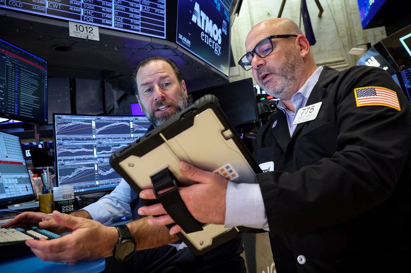 Traders work on the floor at the New York Stock Exchange (NYSE) in New York City, U.S., April 13, 2026.  REUTERS/Brendan McDermid