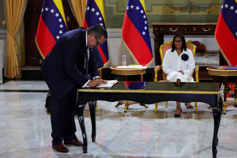 Venezuela's interim President Delcy Rodriguez looks on as Mariano Vela, President of Chevron in Venezuela signs an oil agreement between Chevron and Venezuela's state oil company PDVSA, in Caracas, Venezuela April 13, 2026. REUTERS/Leonardo Fernandez Viloria