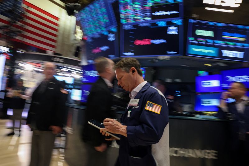 Traders work on the floor at the New York Stock Exchange (NYSE) in New York City, U.S., April 8, 2026. REUTERS/Brendan McDermid
