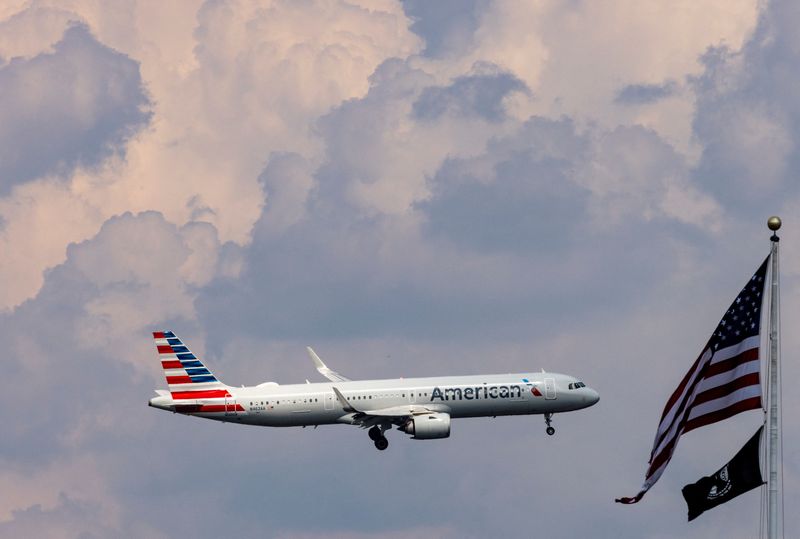 An American Airlines commercial aircraft flies over Washington as it approaches to land at Dulles International Airport, as seen from Washington, U.S., August 5, 2024. REUTERS/ Umit Bektas