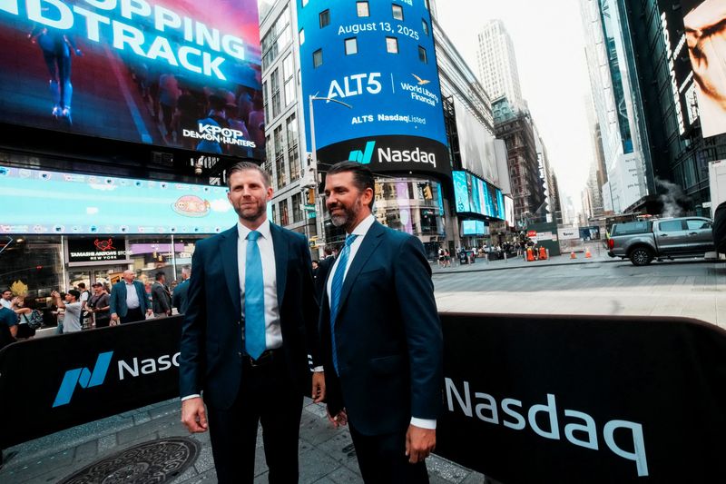 FILE PHOTO: Donald Trump Jr. and Eric Trump pose for pictures outside the Nasdaq building after ringing the opening bell to celebrate the closing of ALT5’s $1.5 billion offering and adoption of its $WLFI Treasury Strategy at the Nasdaq Market, in New York City, U.S., August 13, 2025.  REUTERS/Eduardo Munoz/File Photo
