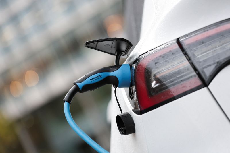An electric car charges, as the government is expected to introduce a tax for drivers of electric vehicles in the upcoming budget, in London, Britain November 24, 2025. REUTERS/Corey Rudy
