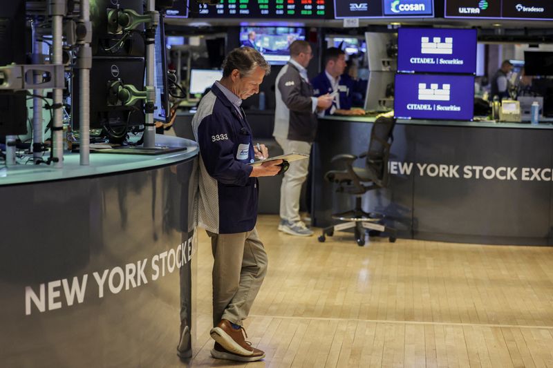 Traders work on the floor at the New York Stock Exchange (NYSE) in New York City, U.S., April 2, 2026. REUTERS/Jeenah Moon