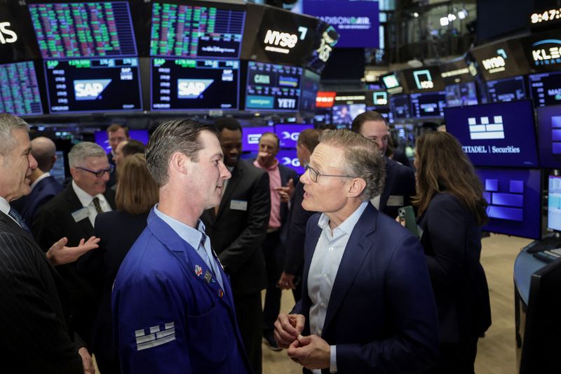 Madison Industries CEO Larry Gies talks with traders at the New York Stock Exchange (NYSE) to celebrate the company’s initial public offering in New York City, U.S., April 16, 2026. REUTERS/Jeenah Moon