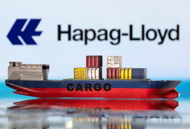 A cargo ship boat model is pictured in front of the Hapag-Lloyd logo in this illustration taken March 3, 2022. REUTERS/Dado Ruvic/Illustration