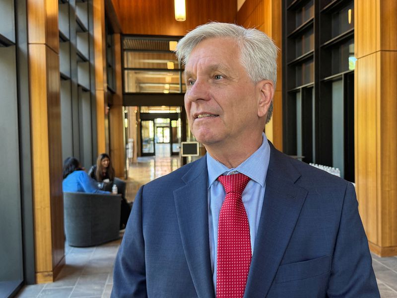 FILE PHOTO: Federal Reserve Governor Christopher Waller converses on the sidelines of a monetary policy conference at Stanford University's Hoover Institution in Palo Alto, California, U.S., May 9, 2025. REUTERS/ Ann Saphir/File Photo