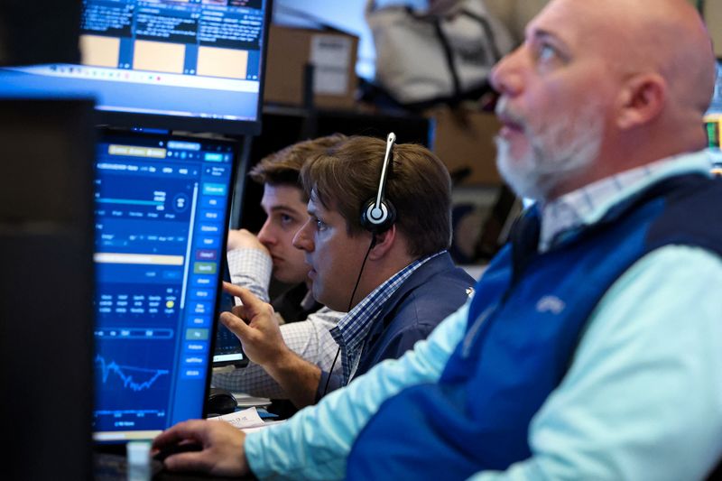 Traders work on the floor at the New York Stock Exchange (NYSE) in New York City, U.S., April 17, 2026.  REUTERS/Brendan McDermid