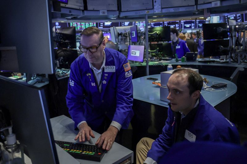 Traders work on the floor at the New York Stock Exchange (NYSE) in New York City, U.S., April 16, 2026. REUTERS/Jeenah Moon