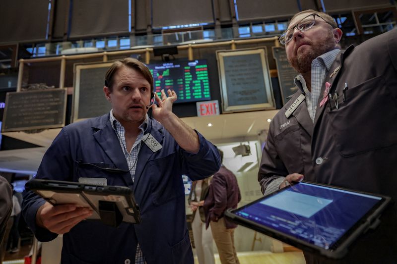 Traders work on the floor at the New York Stock Exchange (NYSE) in New York City, U.S., April 16, 2026. REUTERS/Jeenah Moon