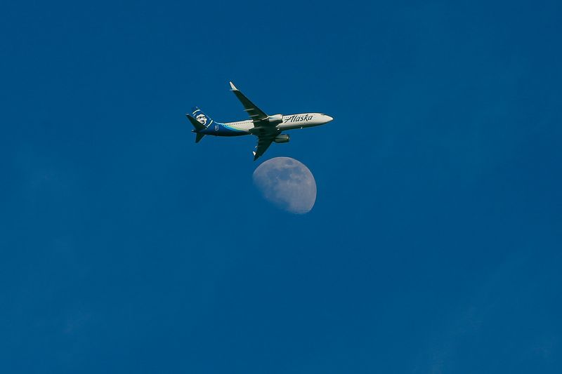 An Alaska Air Boeing 737 MAX flies over downtown Seattle toward SeaTac Airport, in Seattle, Washington, U.S. February 26, 2026.   REUTERS/Genna Martin