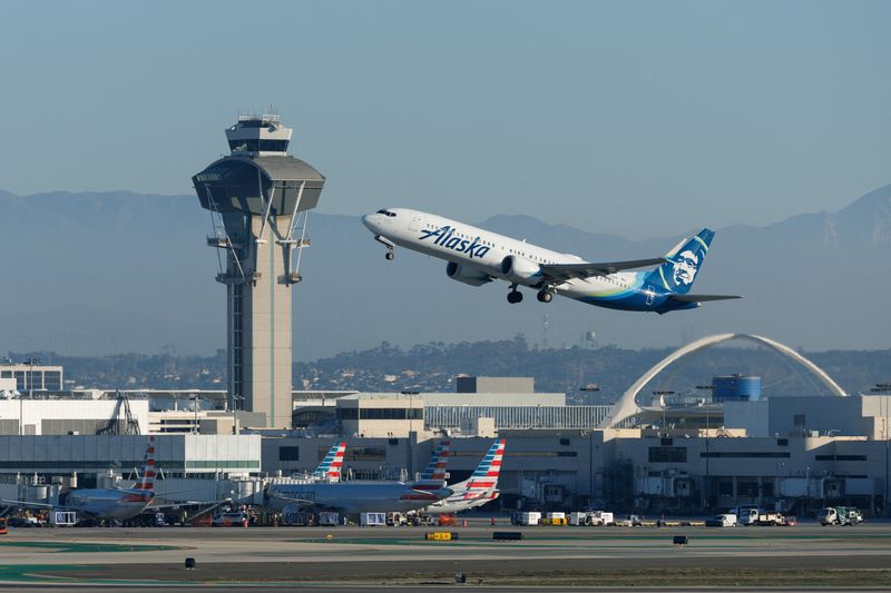 FILE PHOTO: An Alaska Airlines commercial airliner takes-off from Los Angeles International Airport in Los Angeles, California, U.S., November 6, 2025. REUTERS/Mike Blake/File Photo
