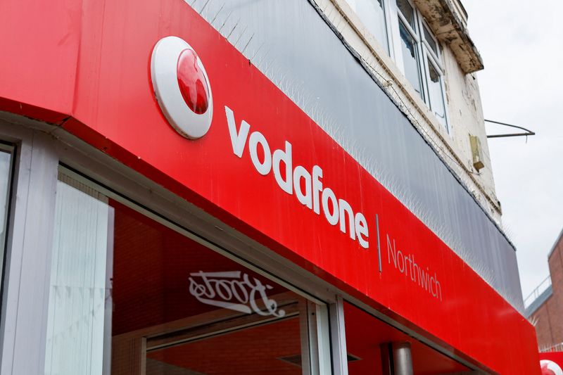 FILE PHOTO: The logo of Vodafone is seen at a Vodafone store in Northwich, Cheshire, Britain, June 7, 2023. REUTERS/Jason Cairnduff/File Photo