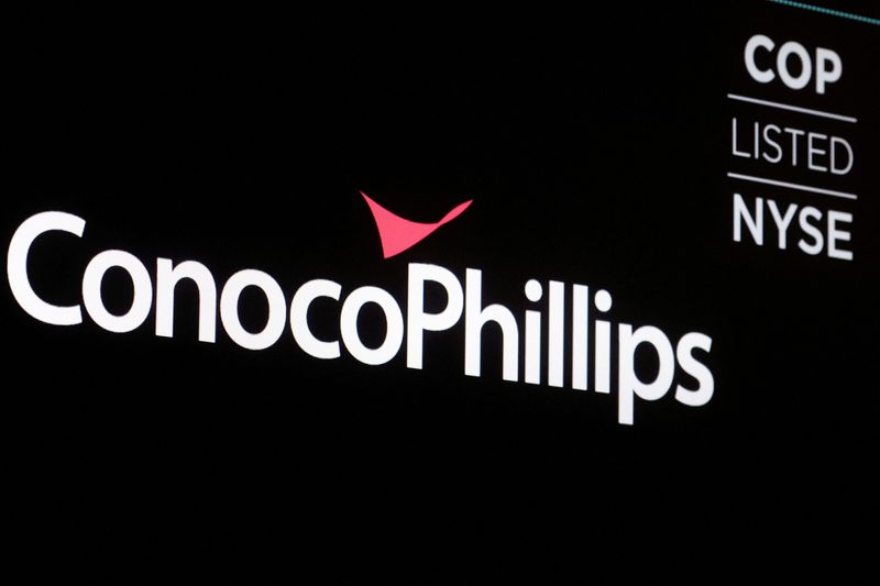 FILE PHOTO: A screen displays the logo for ConocoPhillips on the floor of the New York Stock Exchange (NYSE) in New York City, U.S., April 6, 2022. REUTERS/Brendan McDermid/File Photo