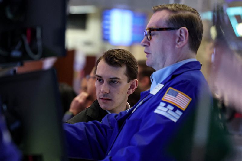 Traders work on the floor at the New York Stock Exchange (NYSE) in New York City, U.S., April 20, 2026.  REUTERS/Brendan McDermid