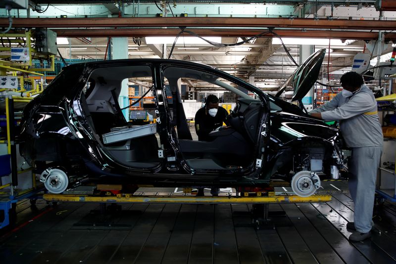 Employees work on the automobile assembly line of Nissan Micra cars at the Renault automobile factory in Flins in France, May 6, 2020. REUTERS/Gonzalo Fuentes