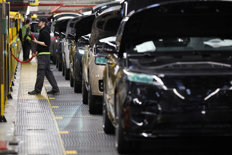 FILE PHOTO: A member of staff works on the production line at Jaguar Land Rover’s factory in Solihull, Britain, December 15, 2022. REUTERS/Phil Noble/ File Photo
