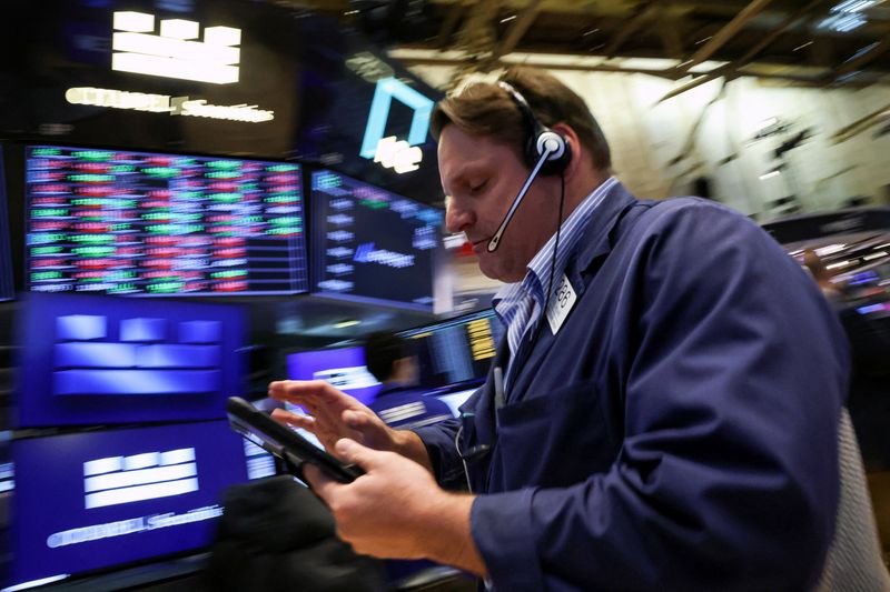 Traders work on the floor at the New York Stock Exchange (NYSE) in New York City, U.S., April 20, 2026.  REUTERS/Brendan McDermid/File Photo
