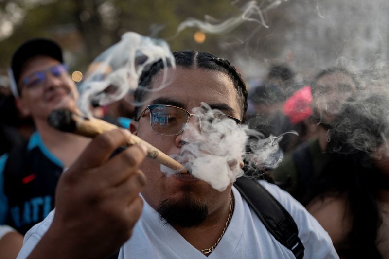 A reveller smokes cannabis at the Mile High 420 Festival in Denver, Colorado, U.S., April 20, 2026.  REUTERS/Cheney Orr