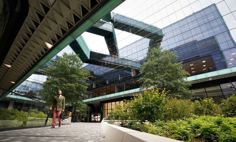 FILE PHOTO: A man walks through a plaza at  the new Fannie Mae headquarters in Washington, U.S., October 4, 2022. REUTERS/Kevin Lamarque/File Photo
