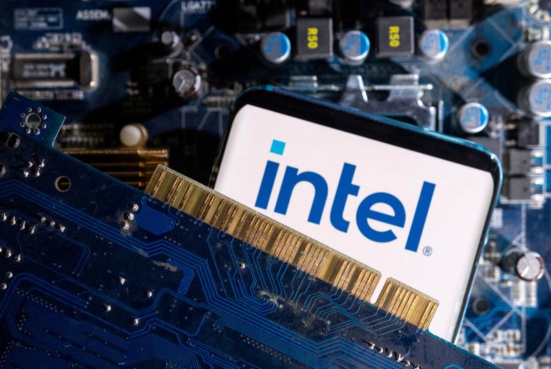 FILE PHOTO: A smartphone with a displayed Intel logo is placed on a computer motherboard in this illustration created on March 6, 2023. REUTERS/Dado Ruvic/Illustration/File Photo