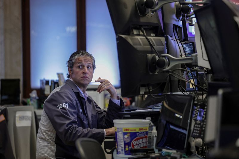 A trader works on the floor at the New York Stock Exchange (NYSE) in New York City, U.S., April 23, 2026. REUTERS/Jeenah Moon/File Photo