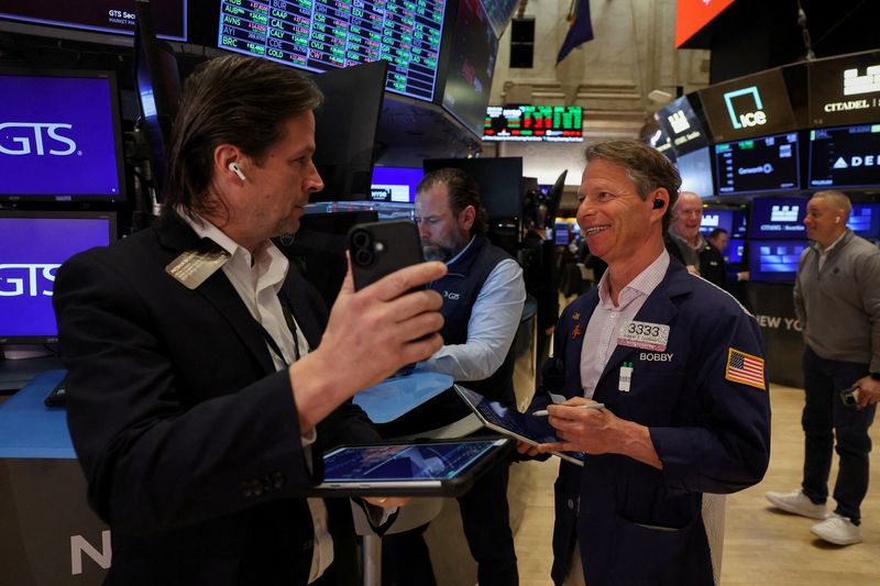 FILE PHOTO: Traders work on the floor at the New York Stock Exchange (NYSE) in New York City, U.S., April 8, 2026. REUTERS/Brendan McDermid/File Photo