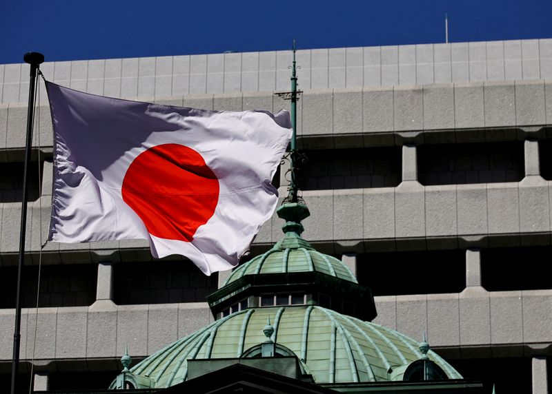 FILE PHOTO: The Japanese national flag flies at the Bank of Japan building in Tokyo, Japan March 18, 2024. REUTERS/Kim Kyung-Hoon/File Photo