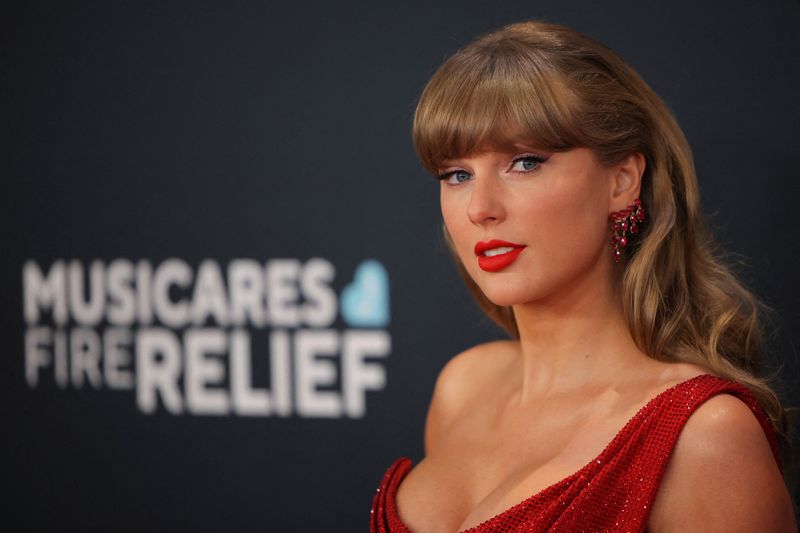FILE PHOTO: Taylor Swift poses at the red carpet during the 67th Annual Grammy Awards in Los Angeles, California, U.S., February 2, 2025. REUTERS/Daniel Cole/File Photo